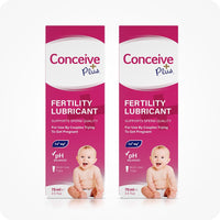 Image of two boxes of Conceive Plus fertility lubricant tube 75ml placed side by side on a white background. Pink boxes with white branding and text have highlights about sperm quality support, pH balance, Calcium and Magnesium ions, multi-use feature, and quantity of the lube. Boxes also feature a smiling baby.