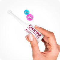 Conceive Plus Women's Fertility Support + Applicators showing a single 4g pre-filled vaginal lubricant applicator held between fingers, with calcium and magnesium ion icons above, displayed on a white background.